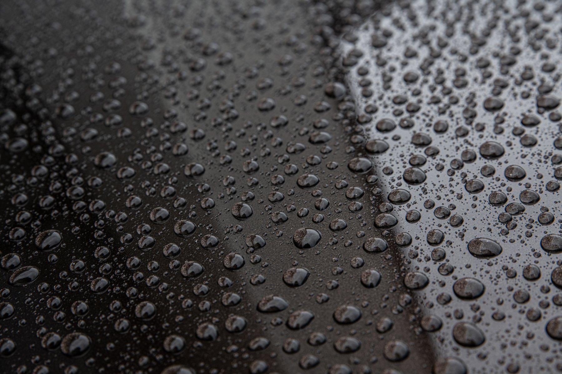 Water drops on car paint. Hydrophobic water effect on car body