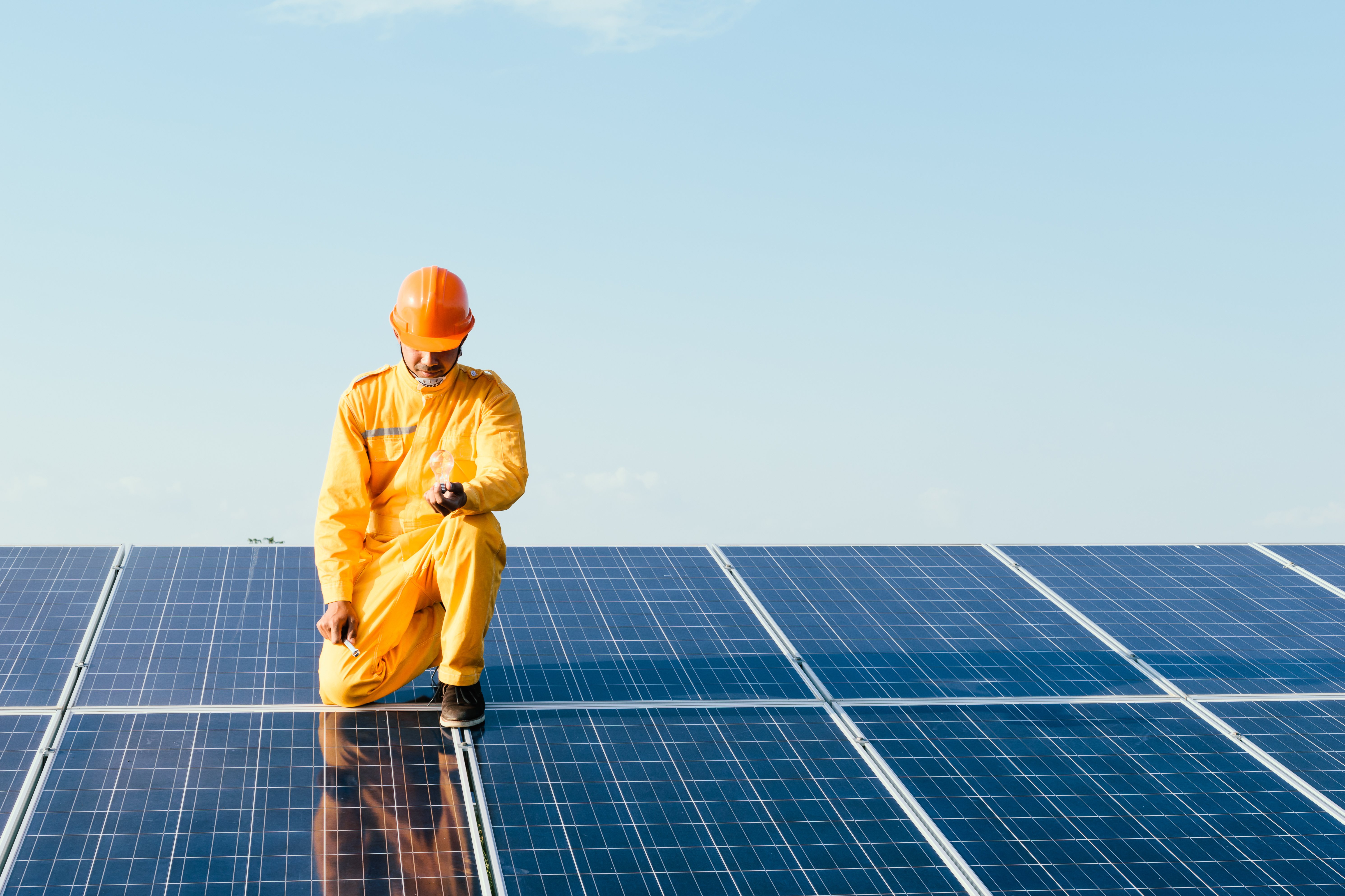 Engineers checking solar panels,Holding the bulb on